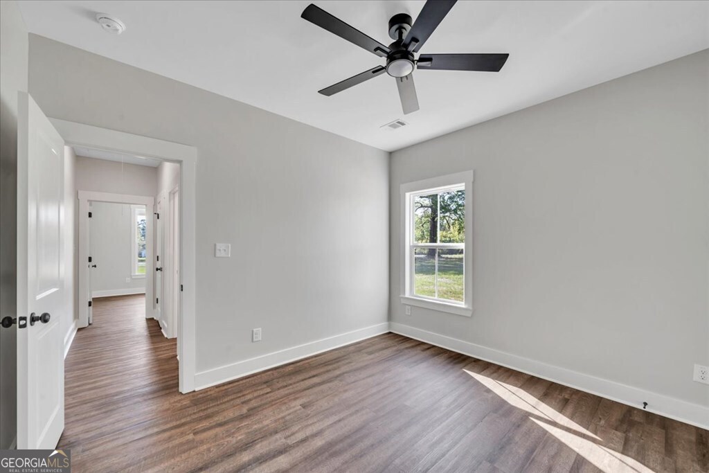 2769 Claxton Dairy Road Dublin, GA 31021 - Photo 34 of 48 a view of a big room with wooden floor and windows