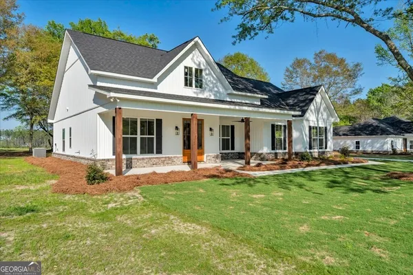 a view of a house with backyard porch and sitting area