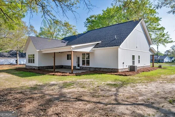 a view of a house with swimming pool and a yard