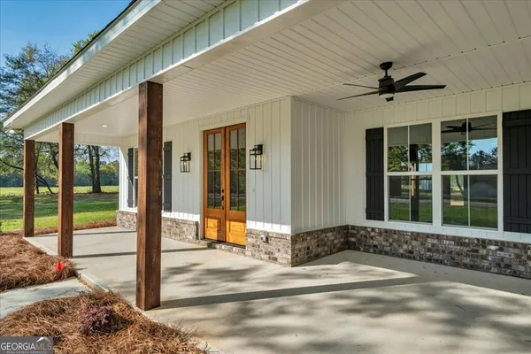 a view of a house with backyard and sitting area