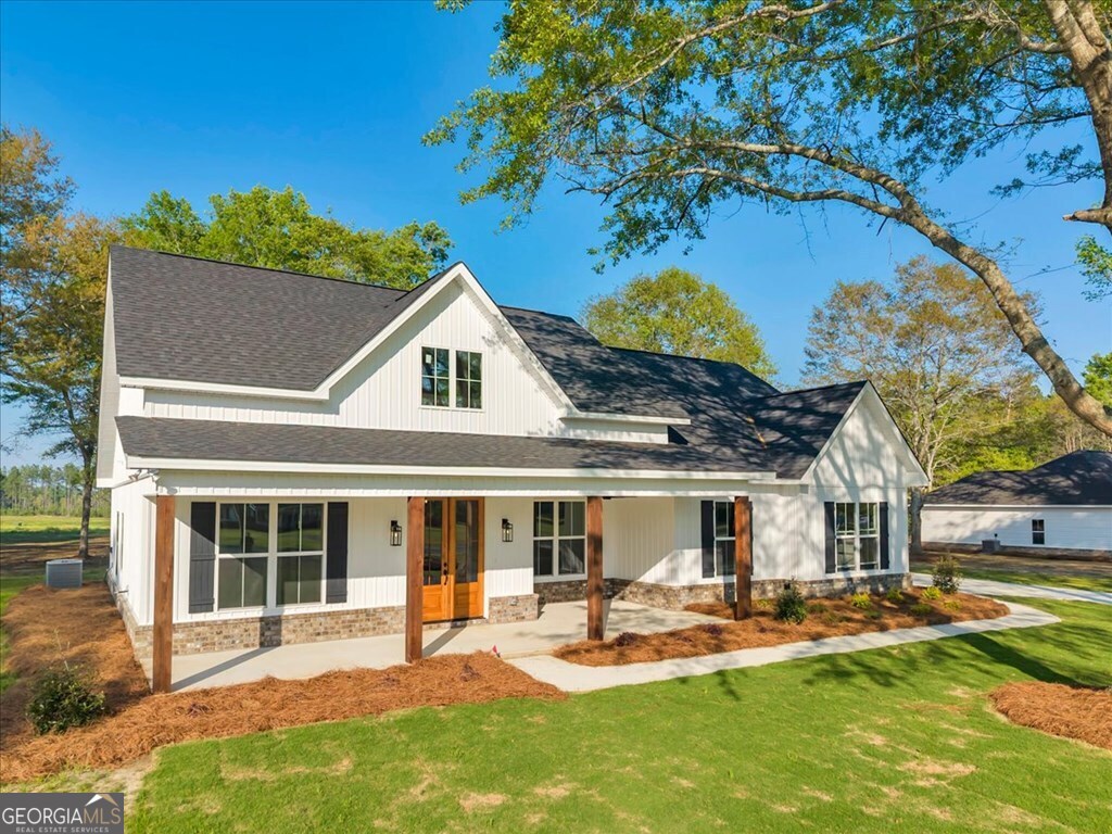 2769 Claxton Dairy Road Dublin, GA 31021 - Photo 47 of 48 a front view of a house with sitting area and garden