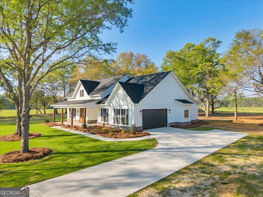 2769 Claxton Dairy Road Dublin, GA 31021 - Photo 48 of 48 a front view of a house with a garden and trees