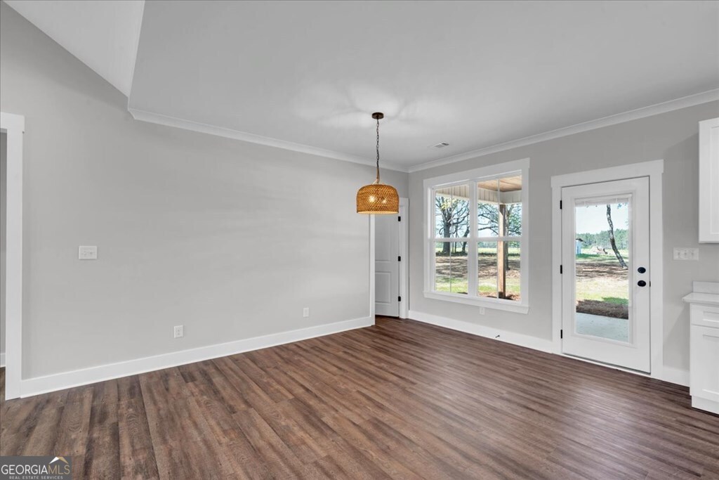 2769 Claxton Dairy Road Dublin, GA 31021 - Photo 6 of 48 an empty room with wooden floor and windows