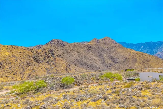 a view of a backyard with table and chairs