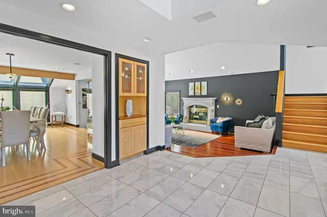 a dining room with furniture a chandelier and wooden floor
