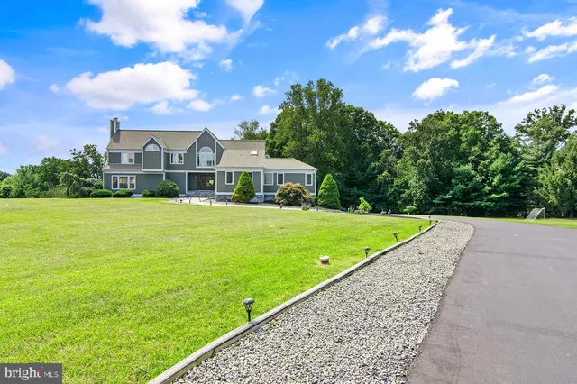 an aerial view of a house with swimming pool a yard and lake view