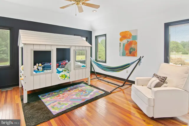 a room with wooden floor and pool table