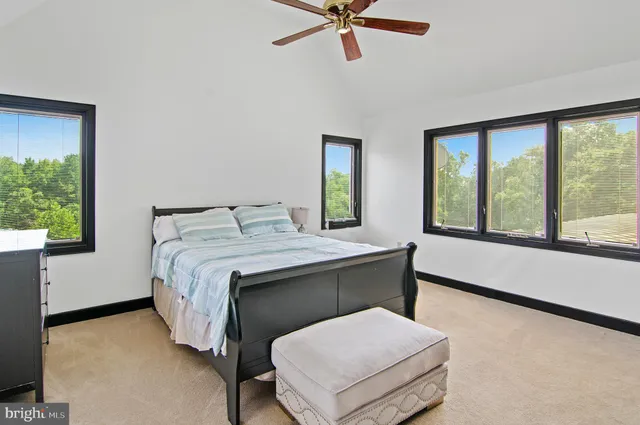 a view of a white house with a fountain plants and a fountain