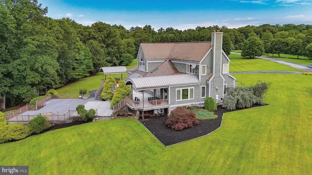 a house with lots of trees in the background