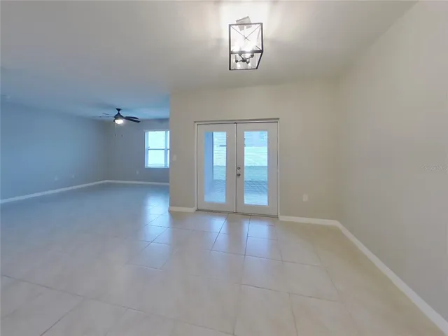 an empty room with windows and entrance