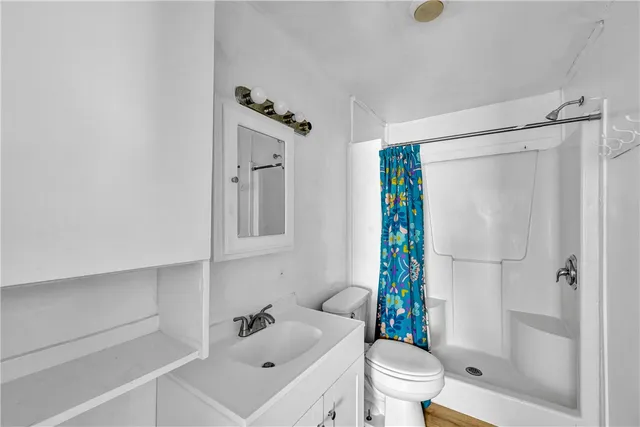 a kitchen with granite countertop a refrigerator and a stove top oven