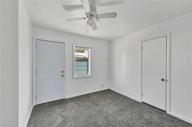 a kitchen with wooden floors and white cabinets