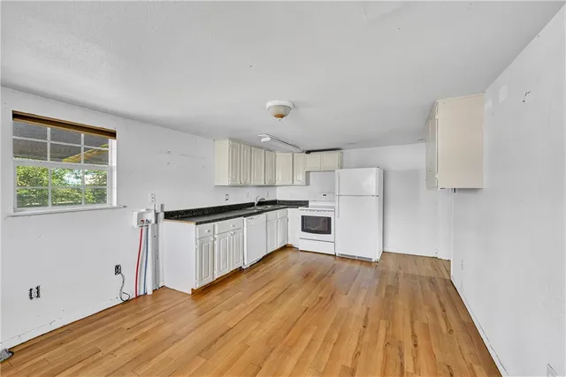 an empty room with a ceiling fan and window