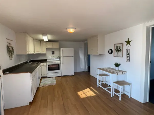 an empty room with a ceiling fan and window