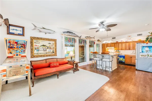 a living room with furniture and kitchen view
