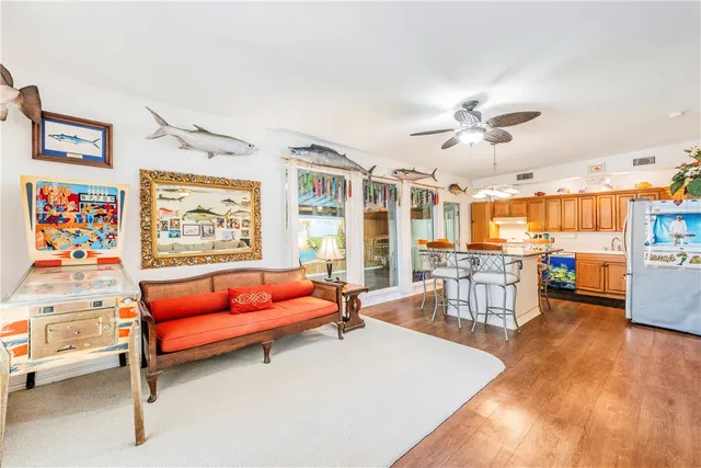 a living room with furniture and kitchen view