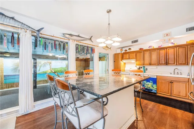 a kitchen with a table chairs and microwave