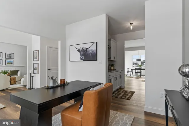 a dining room with furniture and wooden floor