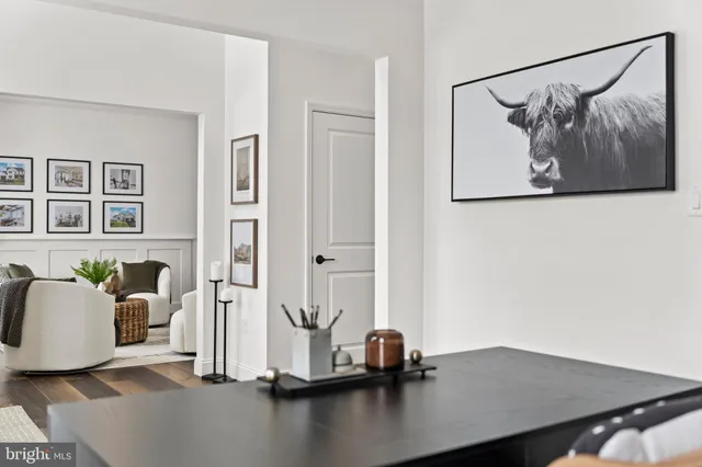 a kitchen with stainless steel appliances kitchen island granite countertop a stove a refrigerator a sink a dining table and chairs with wooden floor