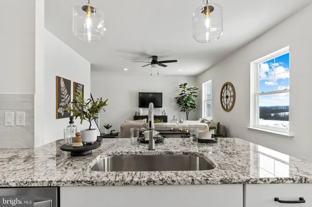a view of a hallway with furniture and wooden floor