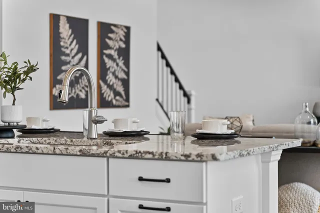 a spacious bedroom with a bed window and dresser