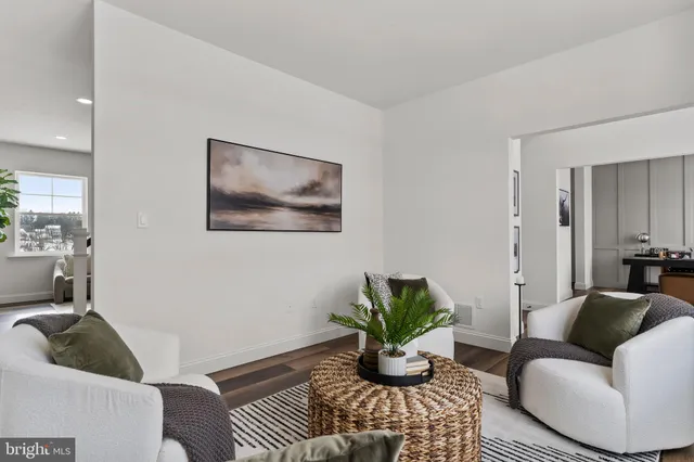 a view of a kitchen with granite countertop a sink and a refrigerator