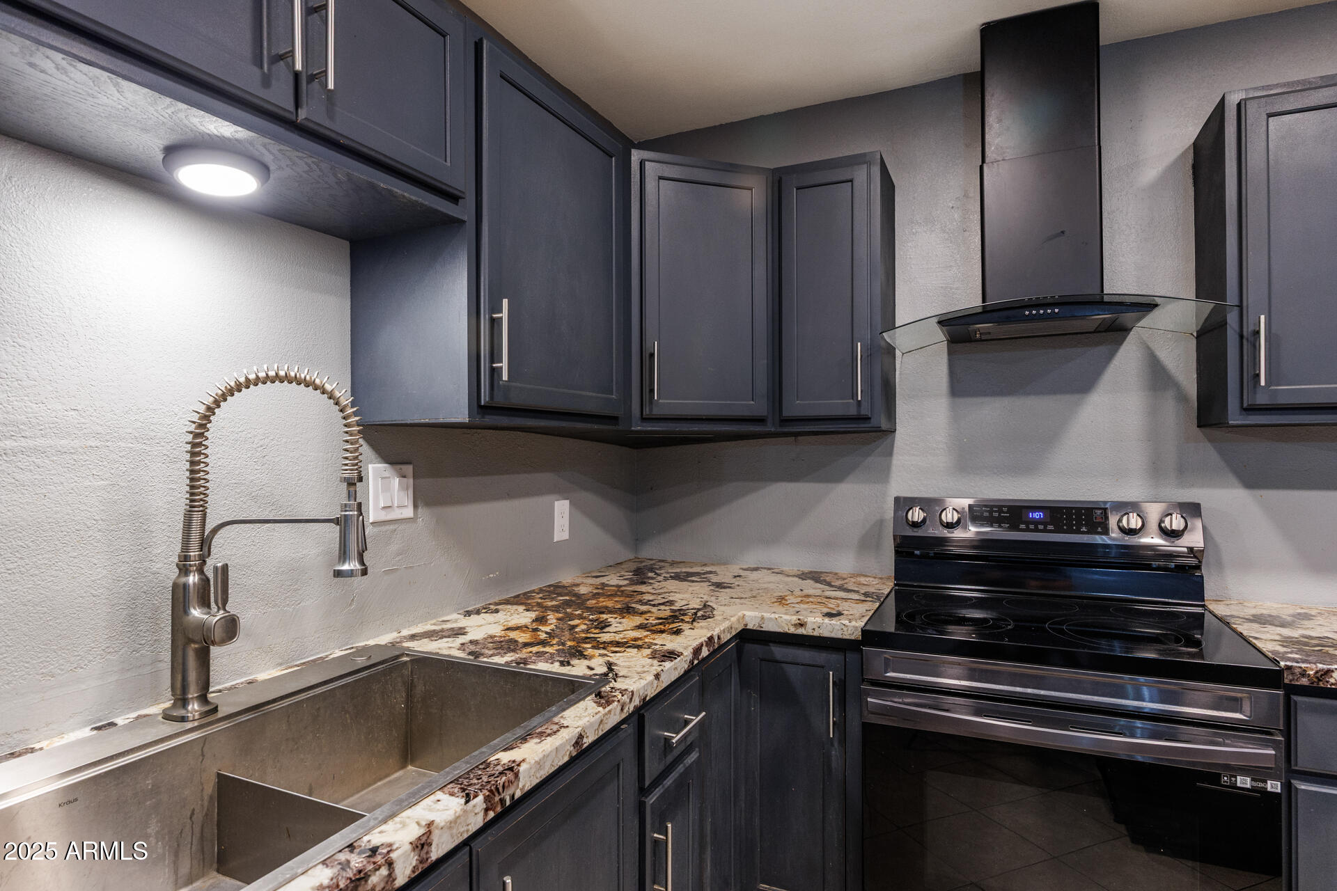 14169 South Tampico Road Arizona City, AZ 85123 - Photo 11 of 38 a kitchen with granite countertop a stove and a sink