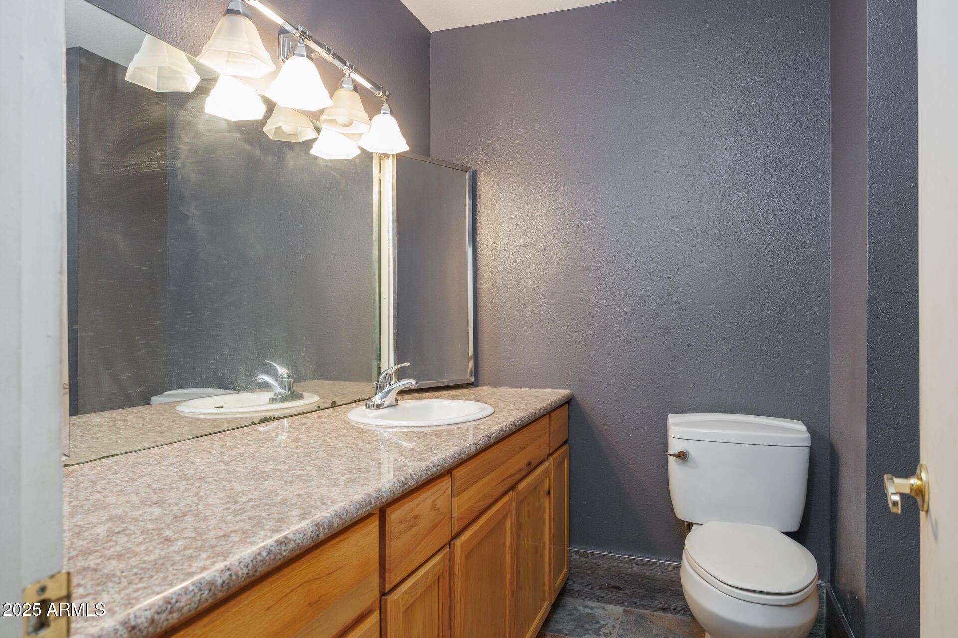 14169 South Tampico Road Arizona City, AZ 85123 - Photo 18 of 38 a bathroom with a granite countertop toilet sink and mirror