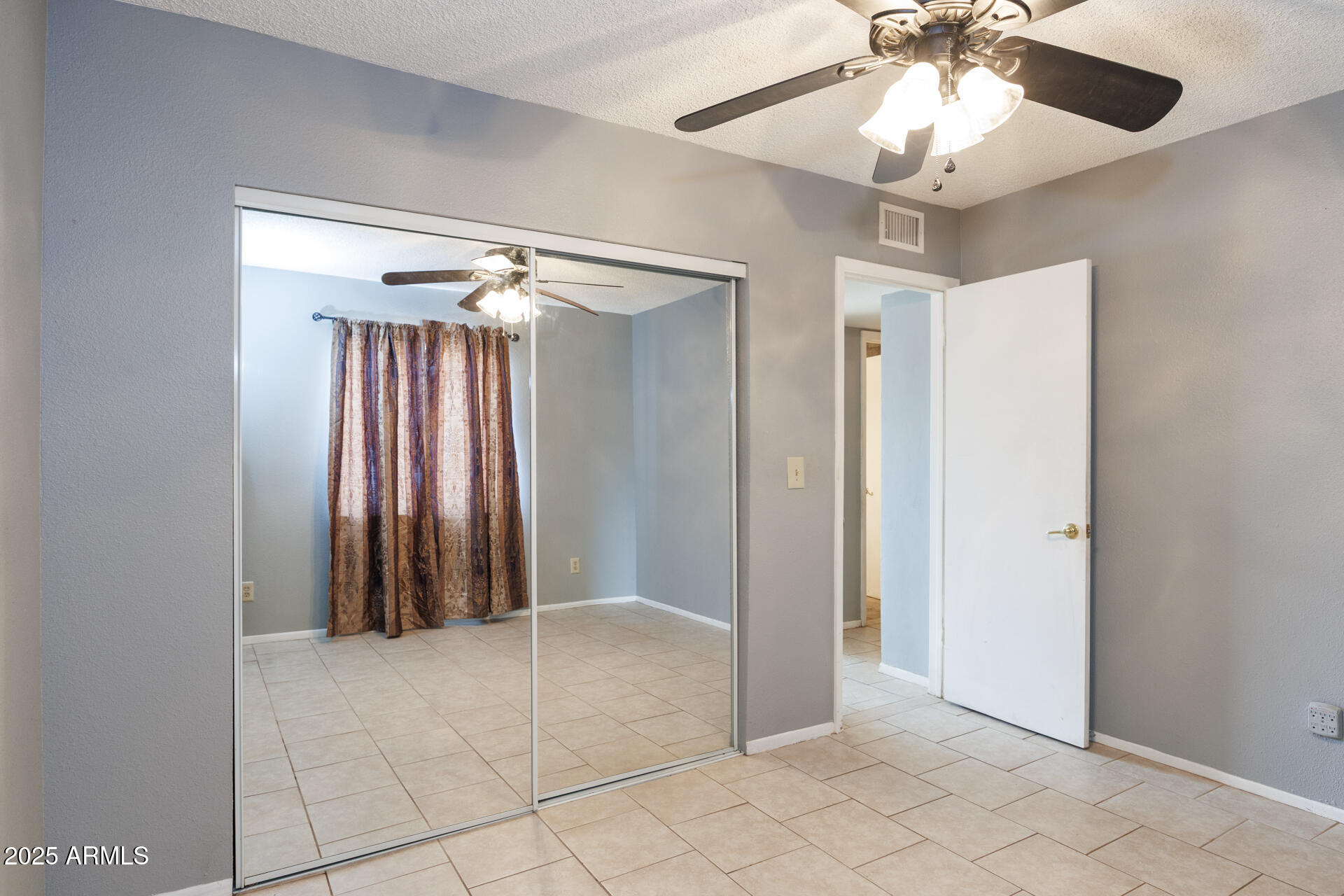 14169 South Tampico Road Arizona City, AZ 85123 - Photo 20 of 38 an empty room with closet and a chandelier fan