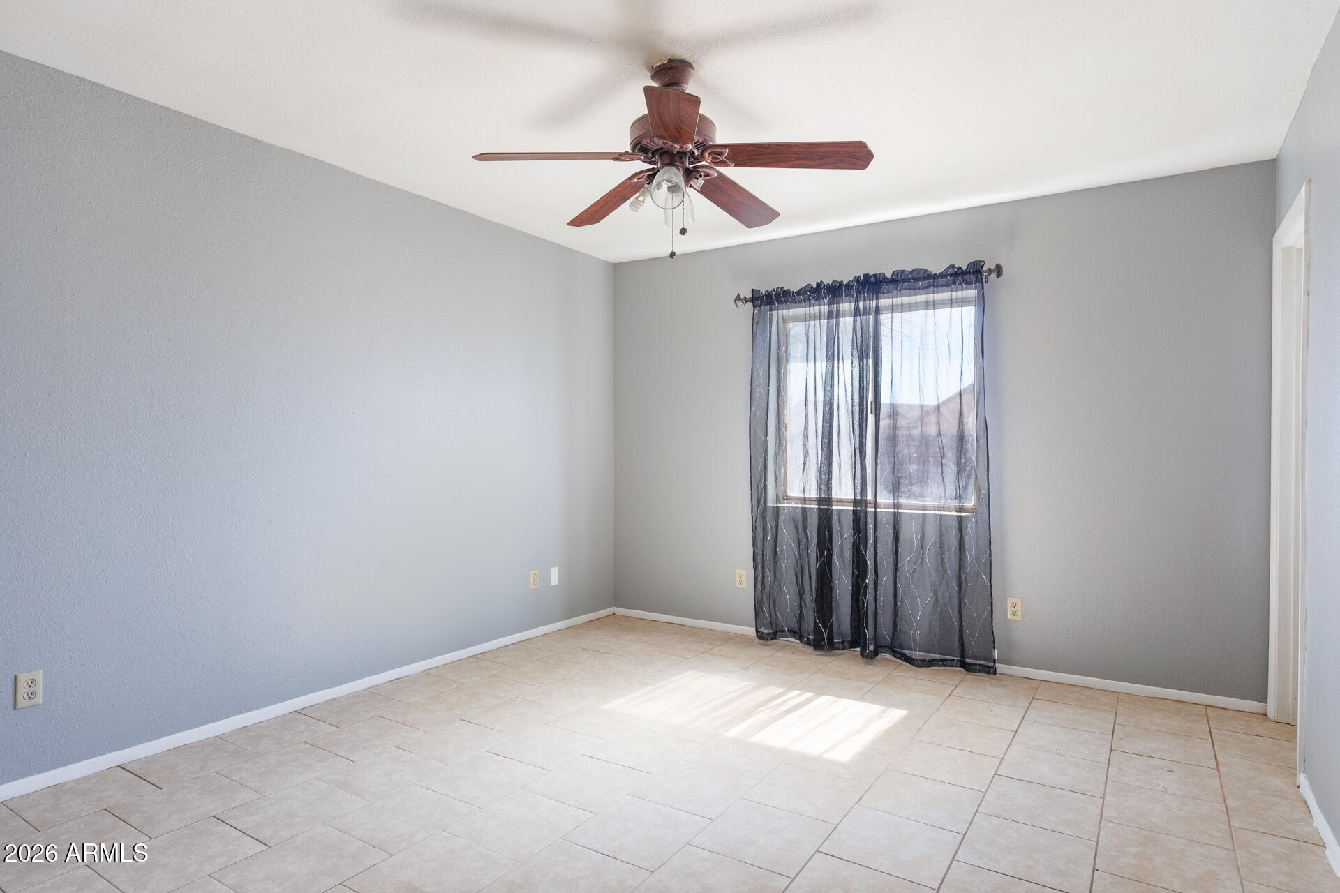 14169 South Tampico Road Arizona City, AZ 85123 - Photo 25 of 38 an empty room with chandelier fan and windows