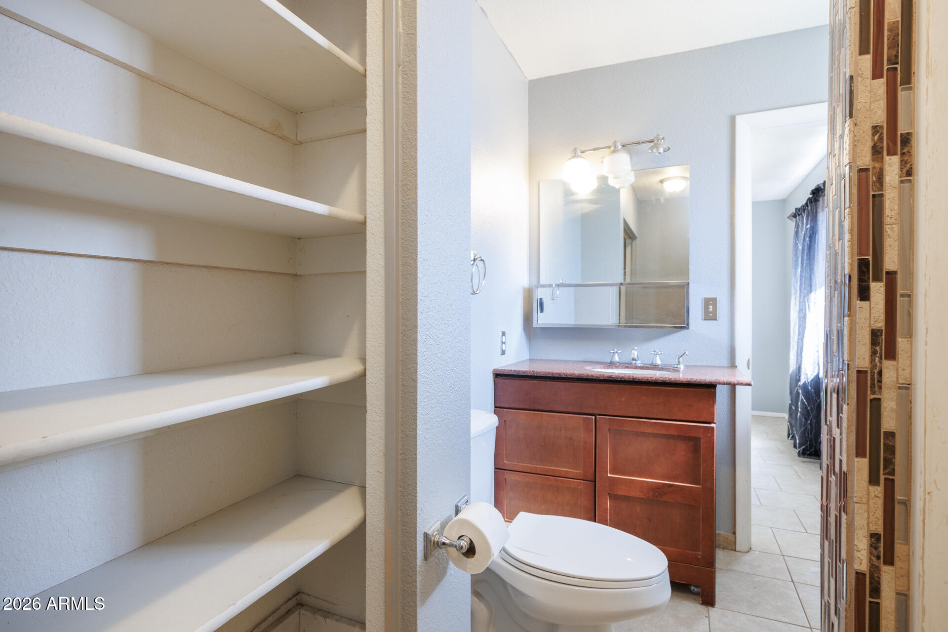 14169 South Tampico Road Arizona City, AZ 85123 - Photo 28 of 38 a bathroom with a granite countertop sink a toilet a shower and a mirror