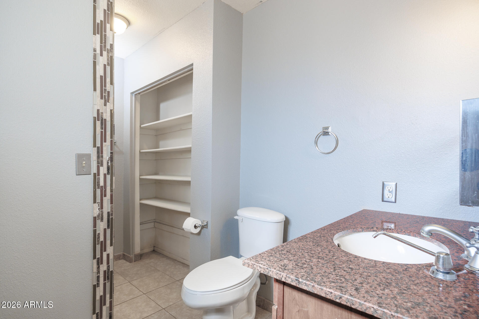 14169 South Tampico Road Arizona City, AZ 85123 - Photo 29 of 38 a bathroom with a granite countertop toilet and a sink
