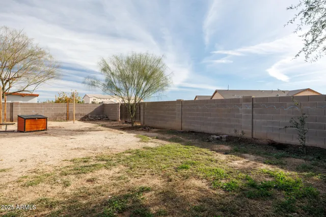 a view of a house with backyard and sitting area