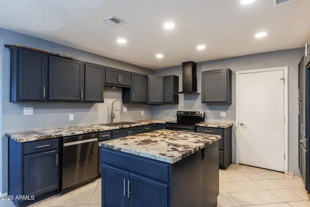 a kitchen with stainless steel appliances granite countertop wooden cabinets stove top oven and sink