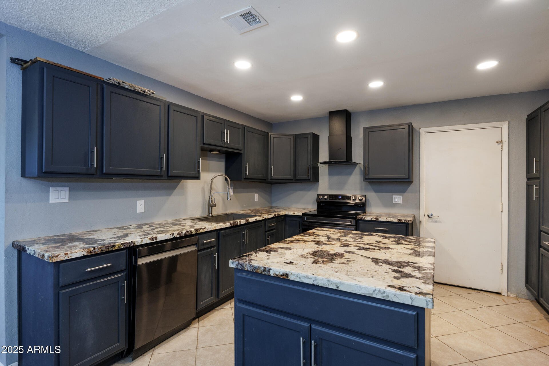 14169 South Tampico Road Arizona City, AZ 85123 - Photo 10 of 38 a kitchen with kitchen island granite countertop stainless steel appliances a sink a stove top oven a counter top space and cabinets