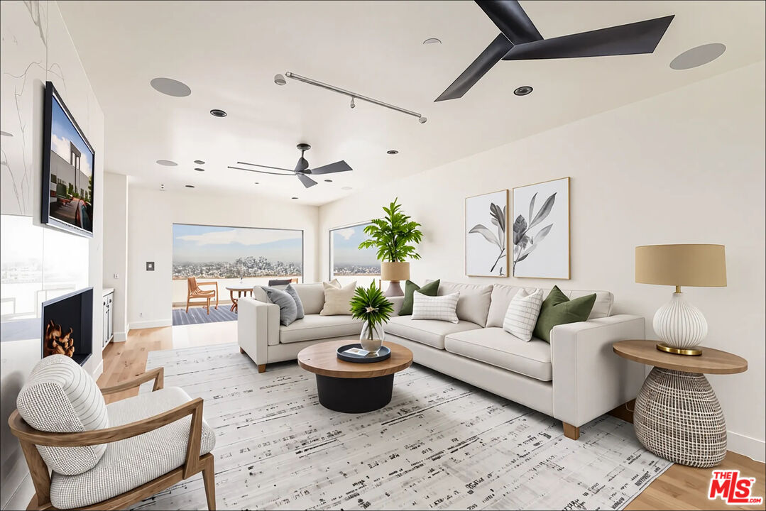 1610 Viewmont Drive Los Angeles, CA 90069 - Photo 17 of 22 a living room with furniture fireplace and a flat screen tv