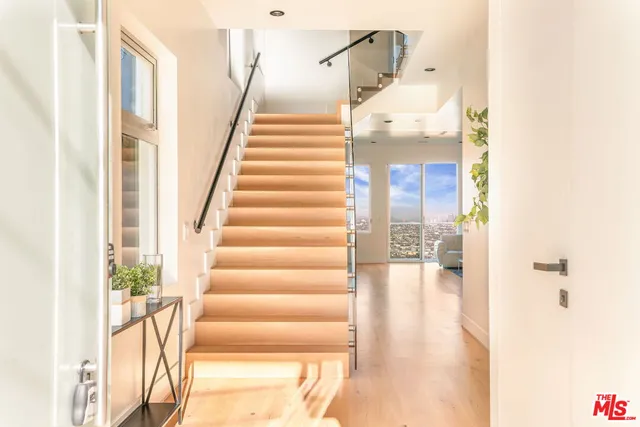 a view of entryway and hall with wooden floor