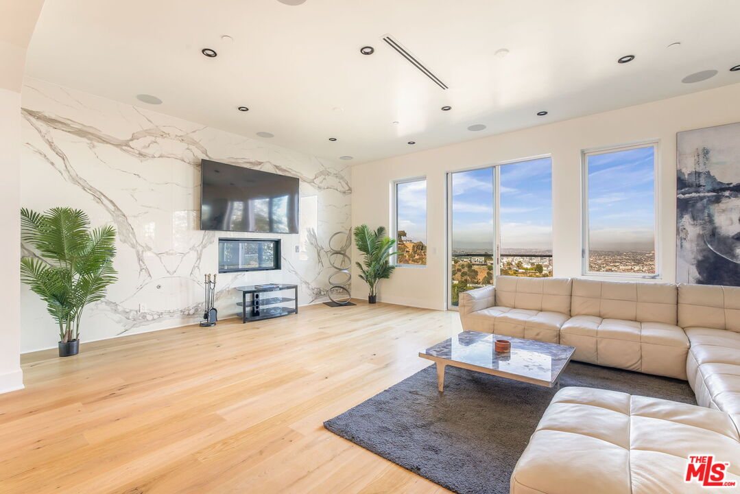 1610 Viewmont Drive Los Angeles, CA 90069 - Photo 3 of 22 a living room with furniture and a large window