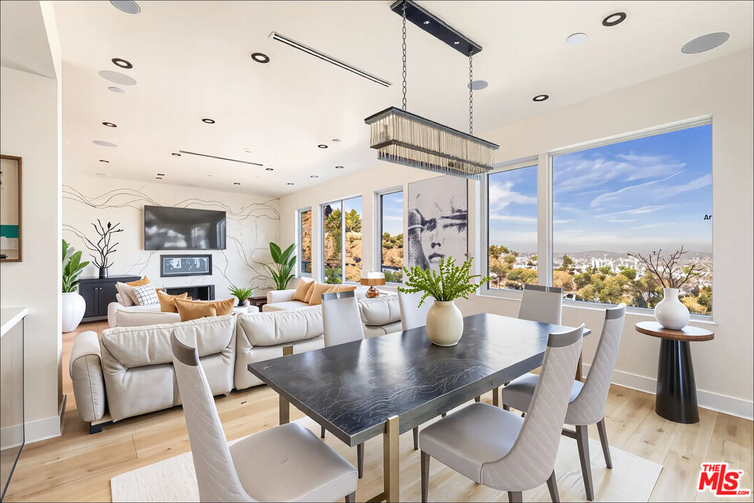 1610 Viewmont Drive Los Angeles, CA 90069 - Photo 5 of 22 a view of a dining room with furniture window and wooden floor