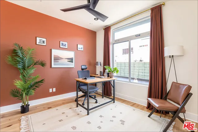 a work room with furniture and a potted plant