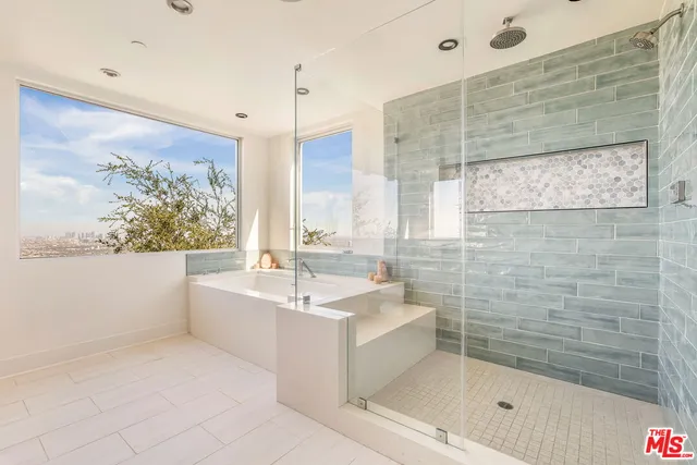 a bathroom with a bathtub and a shower