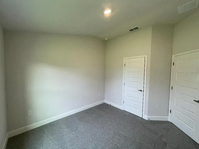 an empty room with closet area