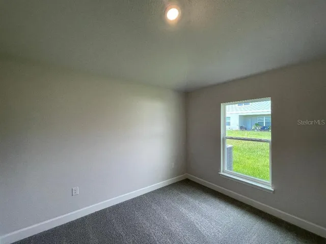 a bathroom with a granite countertop bathtub shower sink vanity mirror and toilet