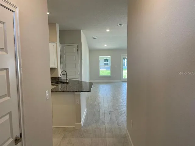 a view of a kitchen with a sink and a refrigerator