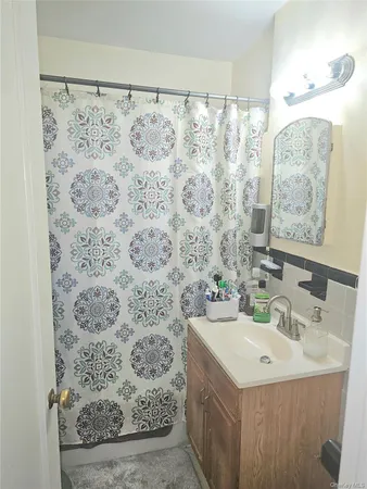 a bathroom with a sink a toilet and mirror