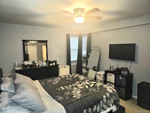 a bedroom with a bed and dresser