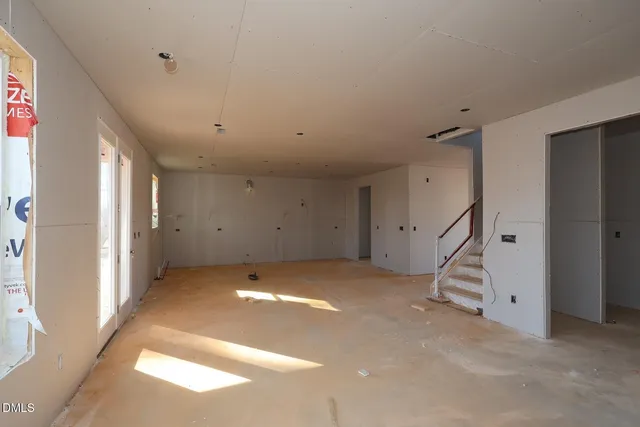 a view of empty room with a fireplace
