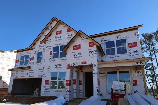 a front view of a building with glass windows and a fireplace