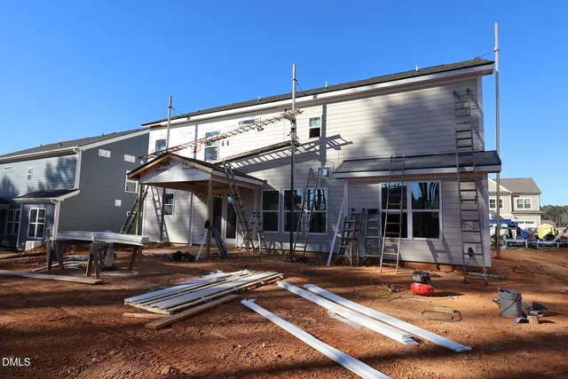 a backyard of a house with barbeque oven table and chairs