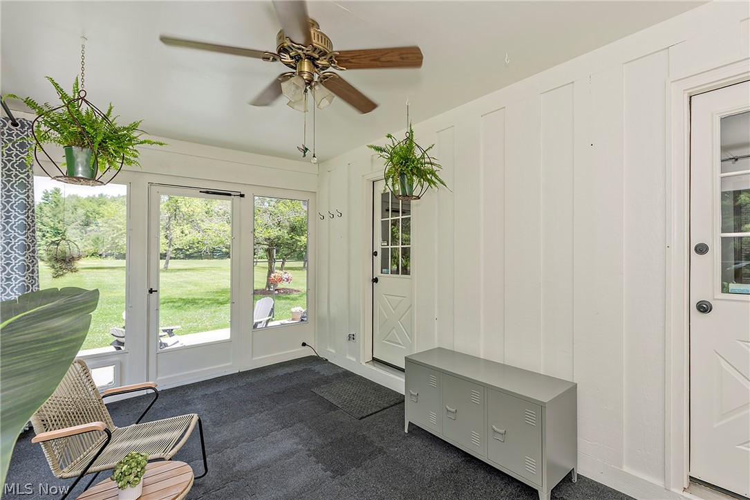 11292 Butternut Road Chardon, OH 44024 - Photo 20 of 49 Bright sunroom featuring multiple glass panel doors, a ceiling fan, and board and batten walls